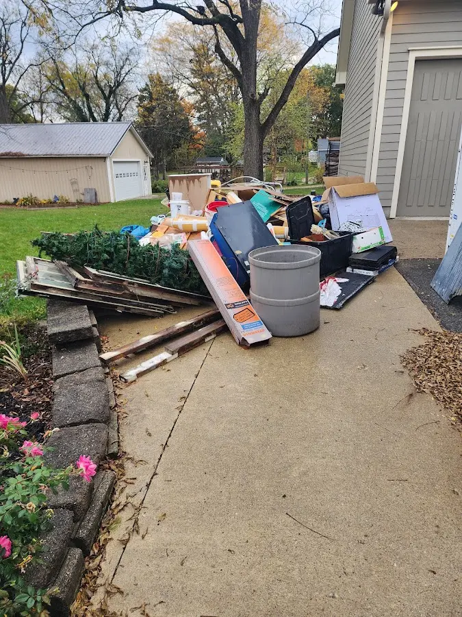 Dumpster being loaded with debris for 12 Yard Dumpster Rental in Bethlehem